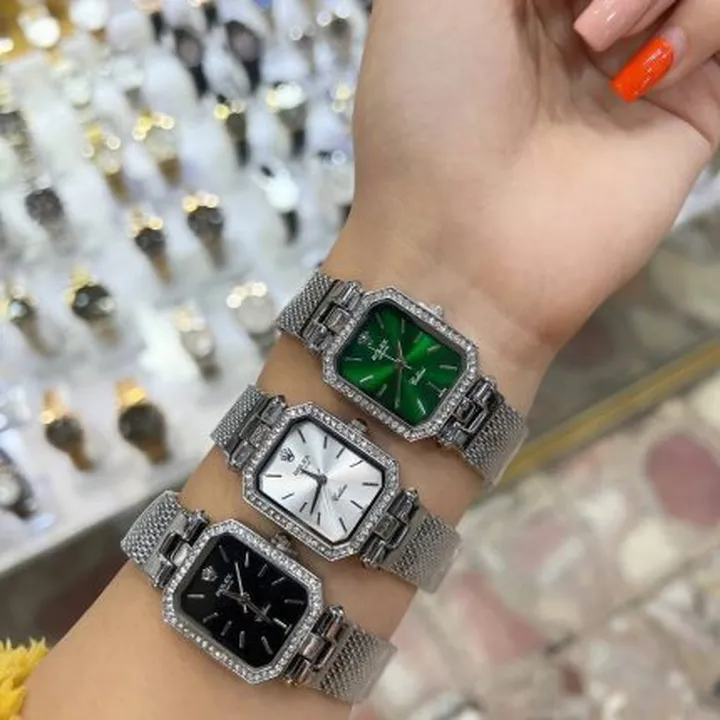 ساعت زنانه رولکس صفحه مستطیلی دور نگینی بند طلایی و نقره ایی – Rolex